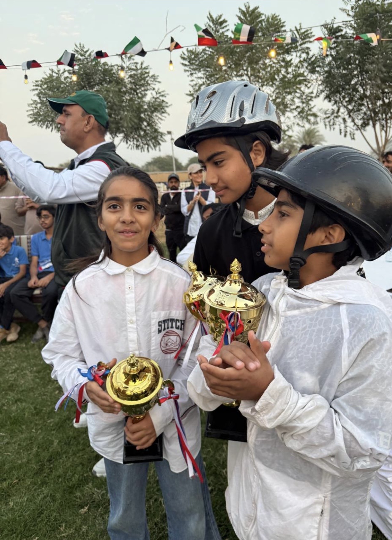 Saif, Meerab, and AbdulSammad after a competition holding trophies